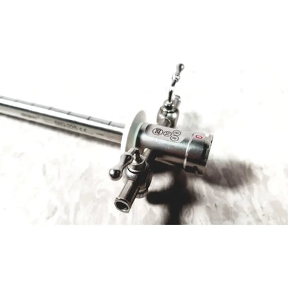 Silver metallic stryker 502-880-225 scope sheath 25fr instrument with slender shaft and complex control head featuring knobs