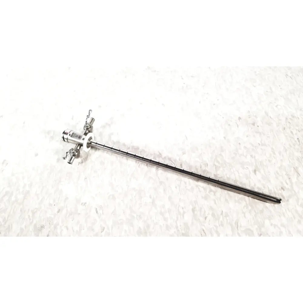 Silver stryker scope sheath 25fr instrument with long slender shaft and multiple adjustment knobs at handle end