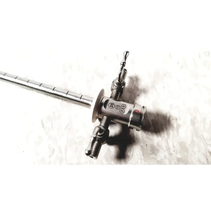 Stainless steel Stryker scope sheath 25fr instrument with long segmented shaft and control head featuring ports and red button