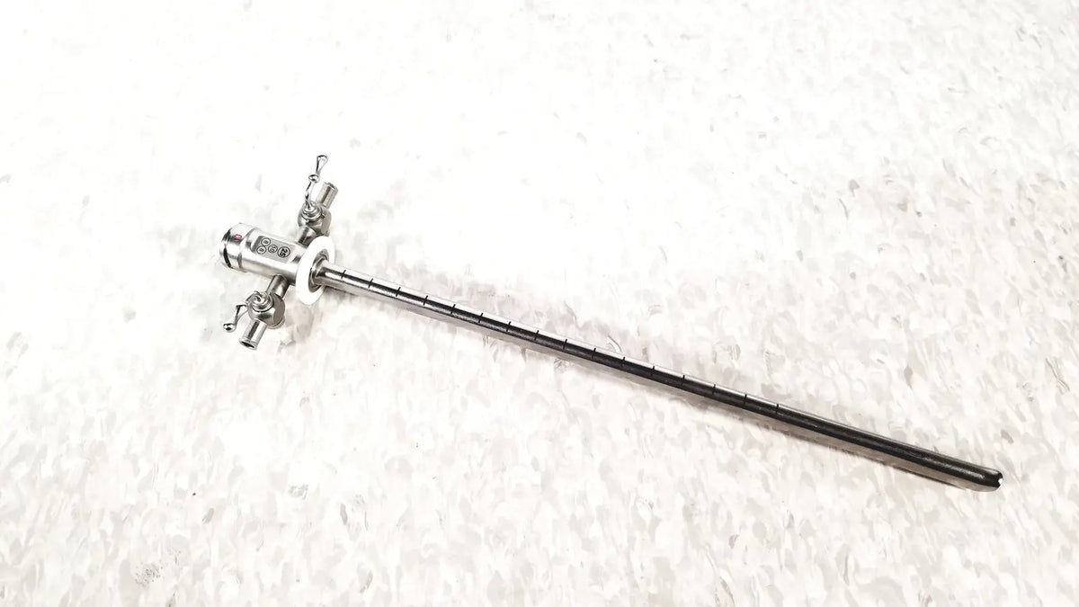 Silver stryker scope sheath 25fr instrument with long slender shaft and multiple adjustment knobs at handle end