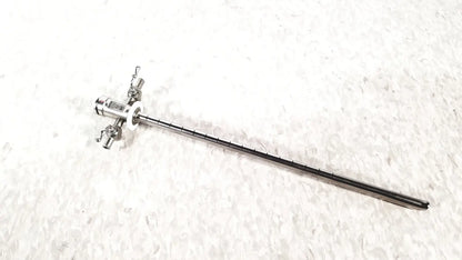 Silver stryker scope sheath 25fr instrument with long slender shaft and multiple adjustment knobs at handle end
