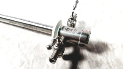 Silver metallic stryker 502-880-225 scope sheath 25fr instrument with slender shaft and complex control head featuring knobs