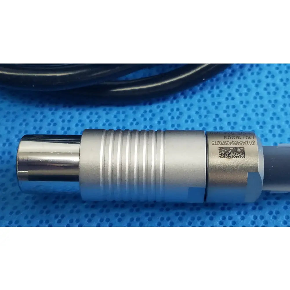 Silver metallic cylindrical sensor with ridged texture and qr code label on the back of stryker 5100-004-000 scher handpiece cable for reuse medical equipment