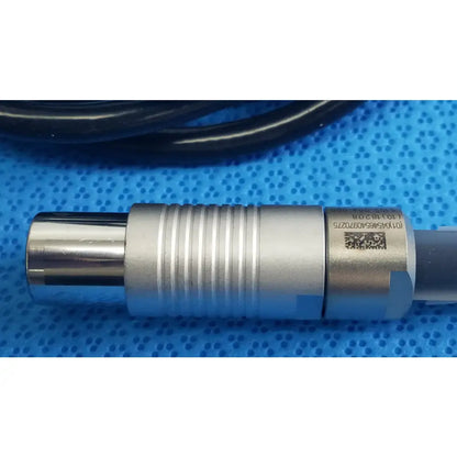 Silver metallic cylindrical sensor with ridged texture and qr code label on the back of stryker 5100-004-000 scher handpiece cable for reuse medical equipment
