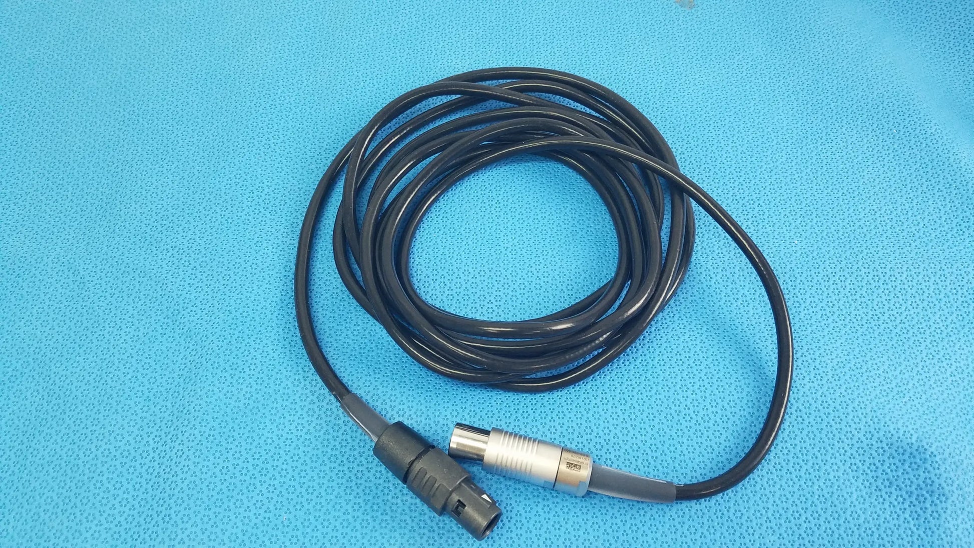 Black coiled scher handpiece cable with black plastic connector and silver metallic xlr plug for reuse medical equipment