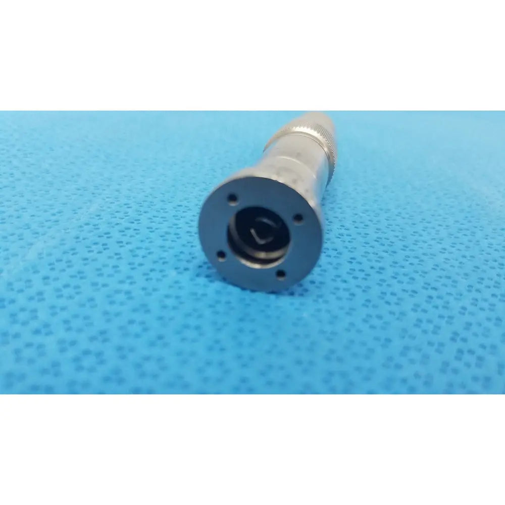 Silver metallic cylindrical connector with threaded grip and four mounting holes for stryker series straight micro drill attachment