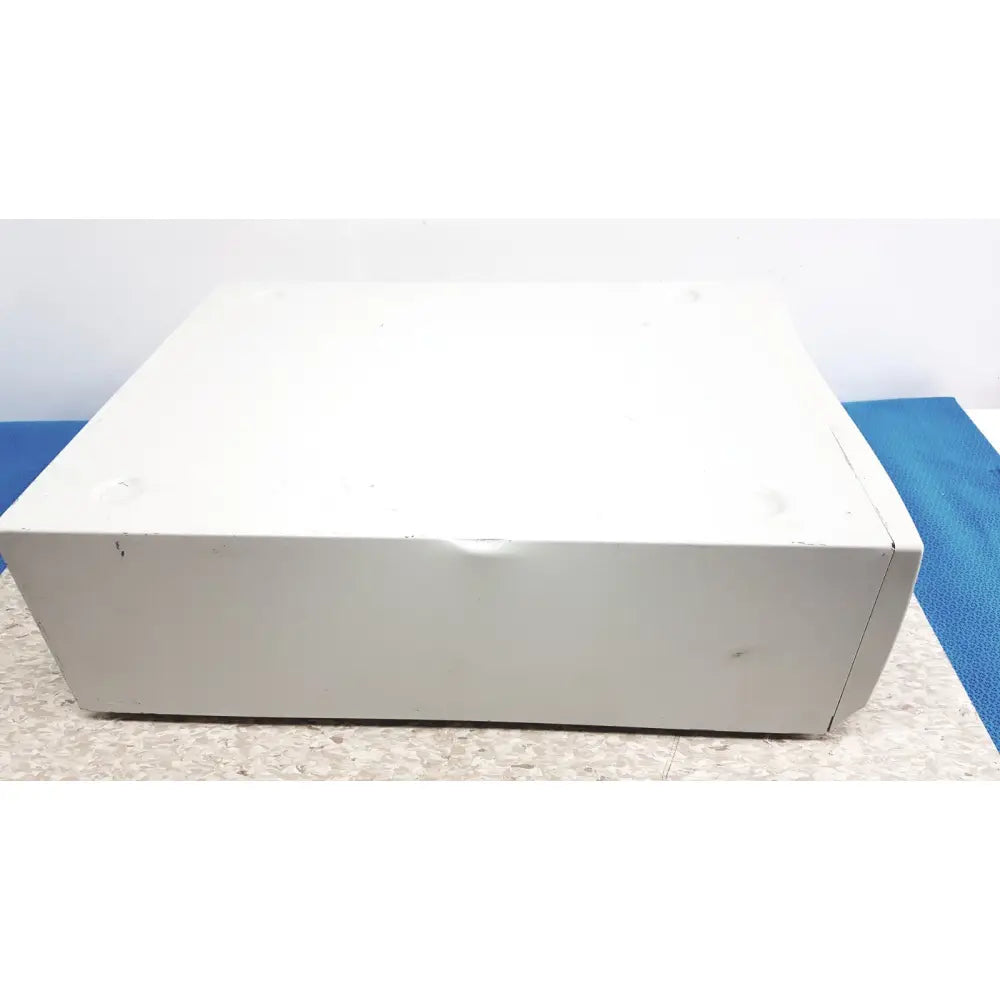 White rectangular Stryker 5400-50 core powered instrument driver surgical handpiece with worn surface and visible seams
