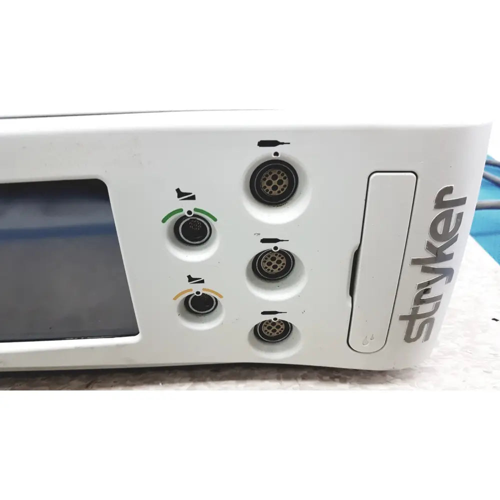 White stryker 5400-50 core powered instrument driver surgical handpiece with circular ports and small screen visible