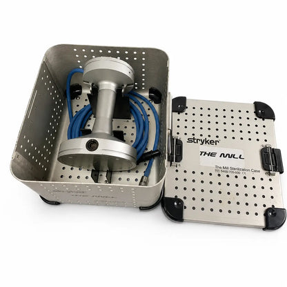Silver stryker mill bone mill with blue connecting cable inside sterilization container for surgical instrument driver use