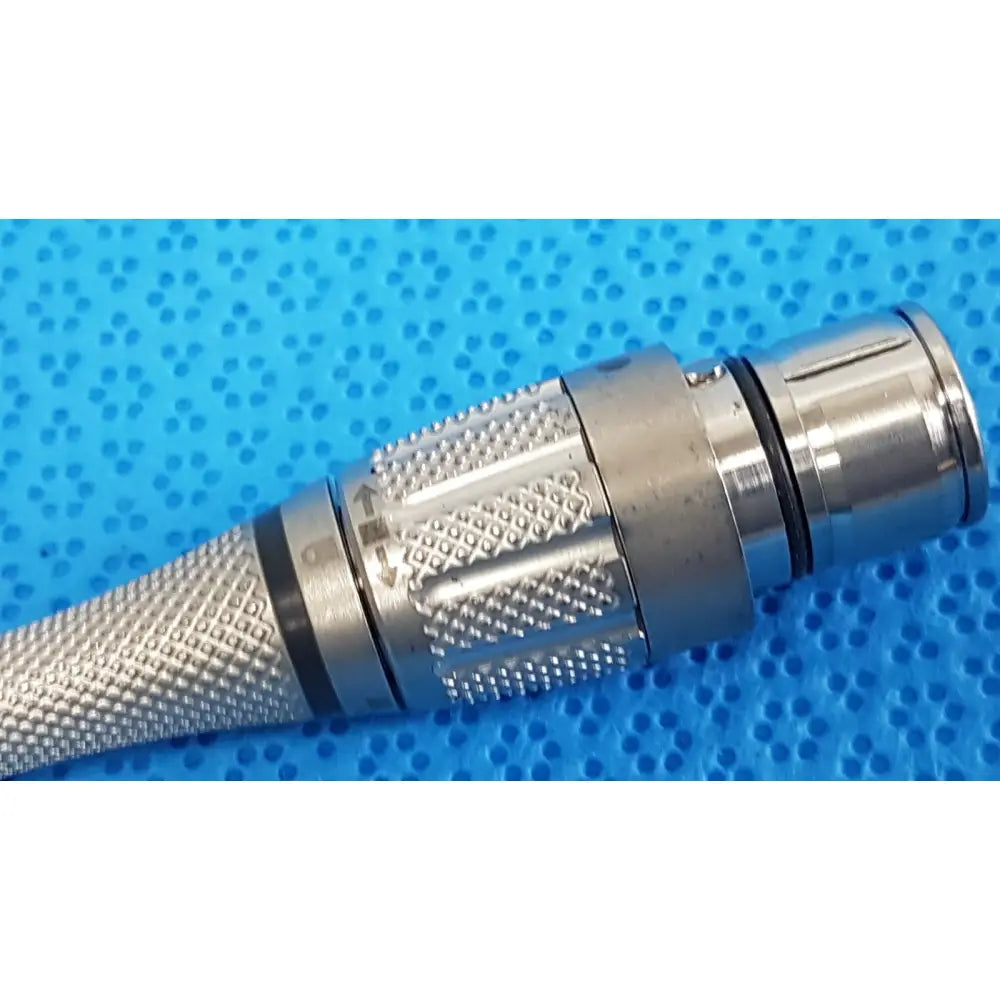Silver metallic coaxial maestro attachment with textured grip and threaded locking ring for surgical power tool components