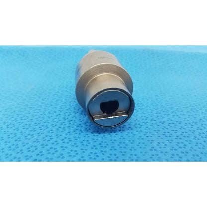 Silver-colored cylindrical metal hudson modified trinkle attachment with circular end keyway and flat metallic plate