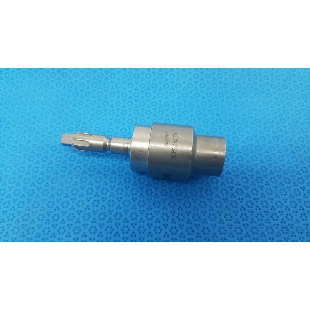 Silver metallic surgical drill bit with cylindrical body and gear-like cutting head for stryker hudson modified trinkle attachment