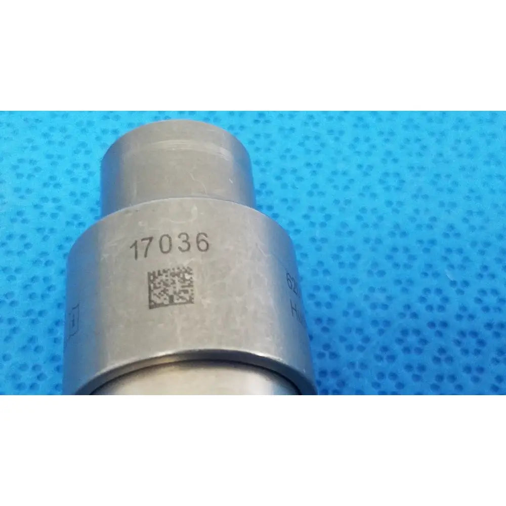 Silver metallic cylindrical hudson modified trinkle attachment with engraved number 17036 and qr code for precision use