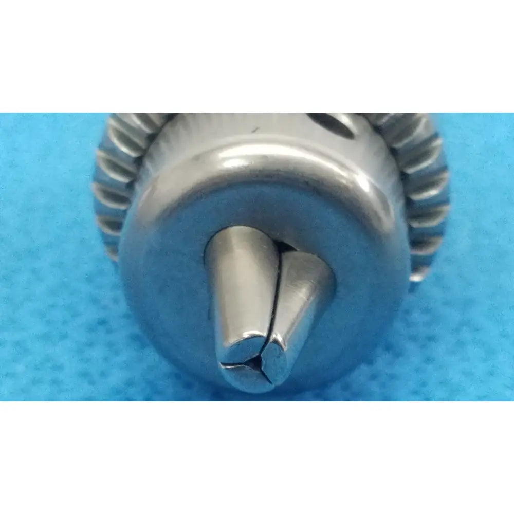 Silver-colored metal drill bit with split-tipped design and gear-like edge for reuse medical stryker 6203-131-000 keyless chuck