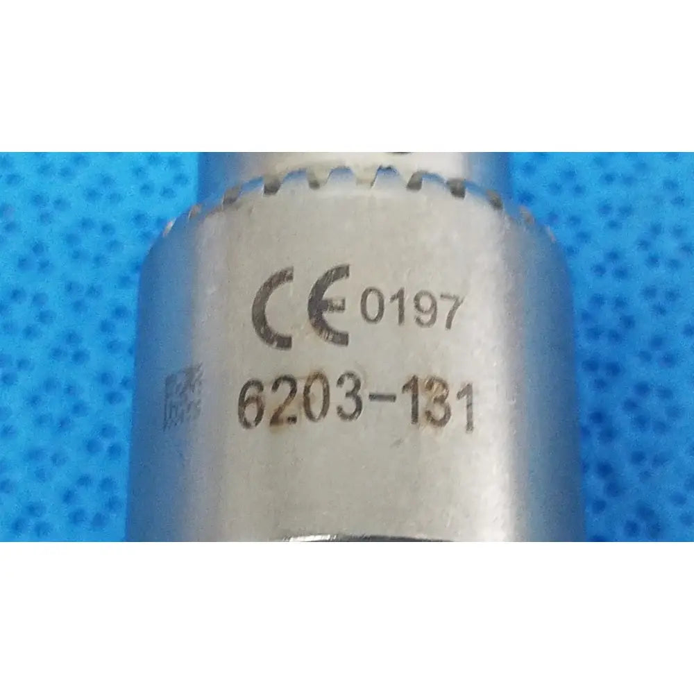 Silver-colored metal socket wrench with keyed chuck and engraved markings 6203-131 for reuse medical applications