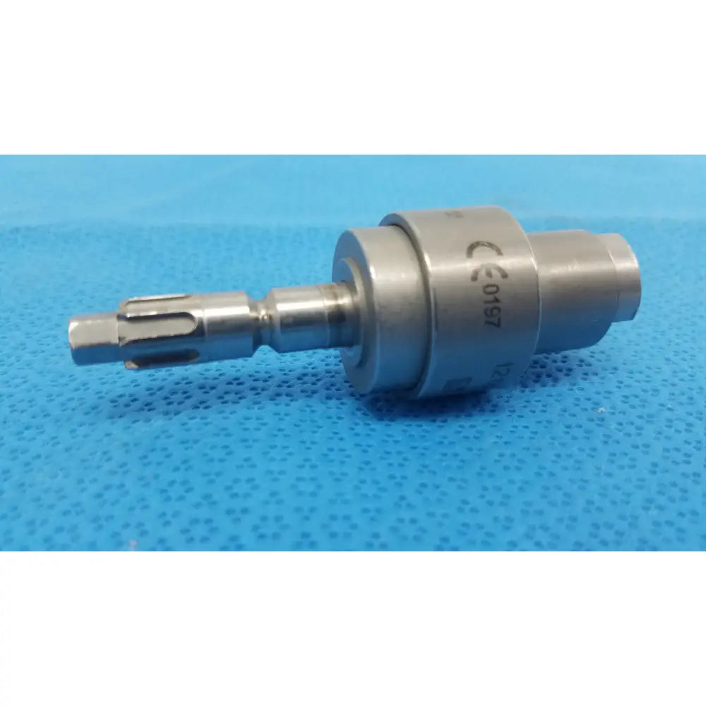 Silver surgical drill bit with textured cylindrical body and precision tip in stryker 6203-135 hudson modified trinkle attachment