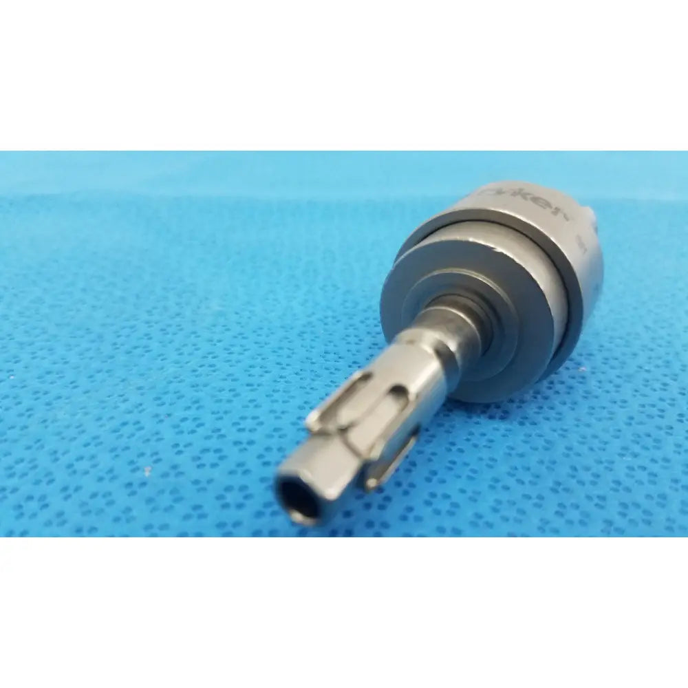 Silver metal drill bit with cylindrical body and threaded shank engraved yken for stryker hudson modified trinkle attachment