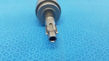 Silver-colored metal dental handpiece with textured cylindrical body and precision-engineered tip for hudson modified trinkle use