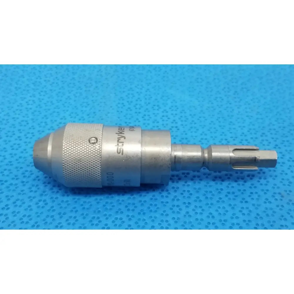 Silver metallic Stryker 6303-110-000 AO small drill bit holder with textured grip and engraved branding for reuse medical use