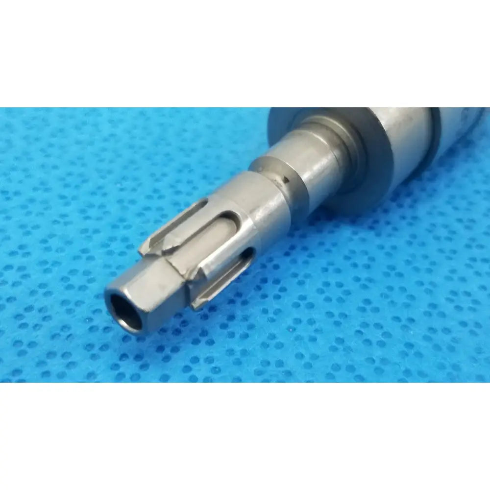 Silver metallic small drill with machined grooves and hexagonal end for reuse medical applications by Stryker