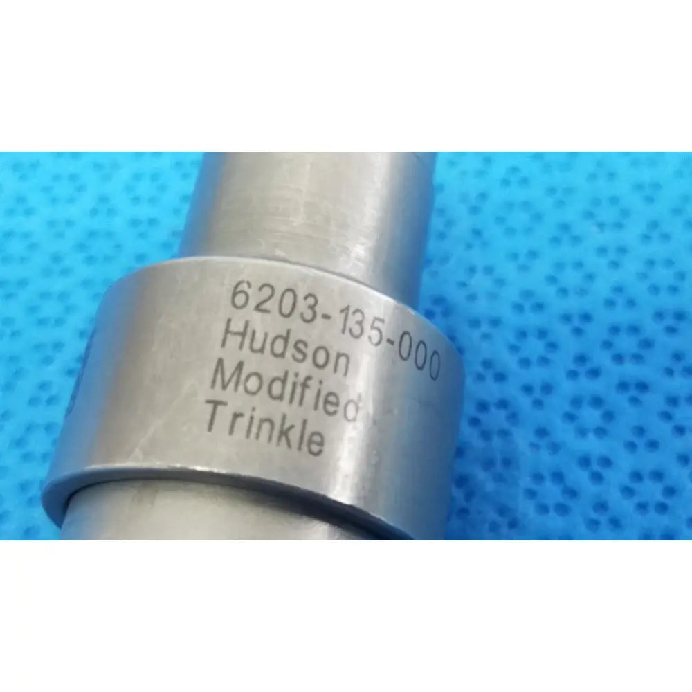 Silver metallic cylindrical component with engraved hudson modified trinkle markings for reuse medical applications