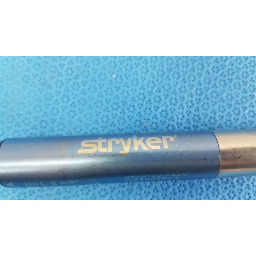 Blue metallic stryker 6400-031-000 remb electric oscillating saw with gold lettering and silver tip surgical instrument