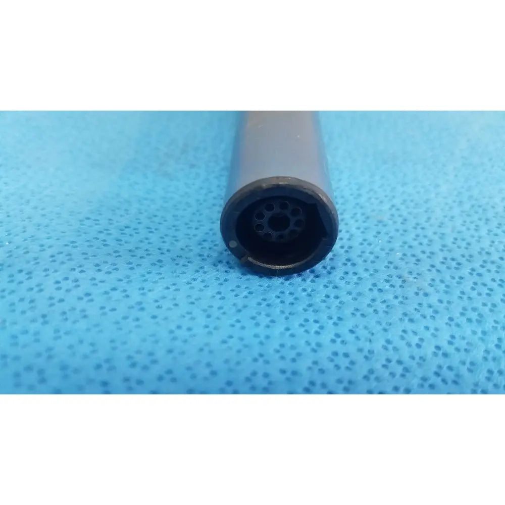 Gray cylindrical remb electric oscillating saw with black perforated end for precise cutting in surgical use