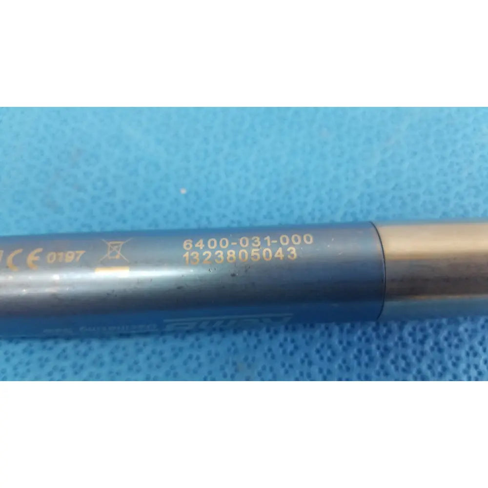 Gray metallic remb electric oscillating saw with gold markings and brass end cap for precise surgical cutting