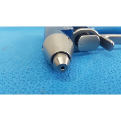 Silver metallic remb wiredriver handpiece with cylindrical nozzle and ergonomic handle for surgical use by stryker