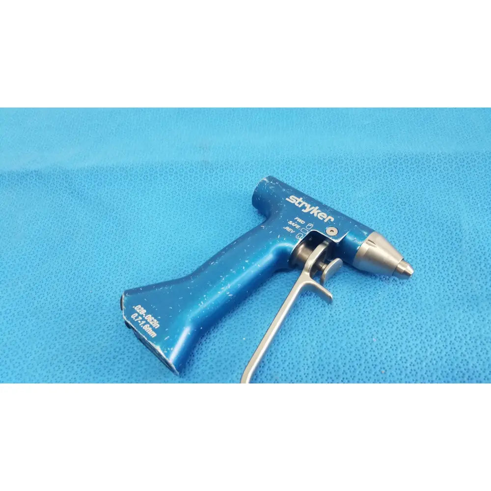 Blue stryker remb wiredriver handpiece featuring a metallic tip and trigger mechanism for surgical use