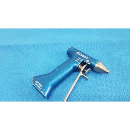 Blue stryker remb wiredriver handpiece featuring a metallic tip and trigger mechanism for surgical use