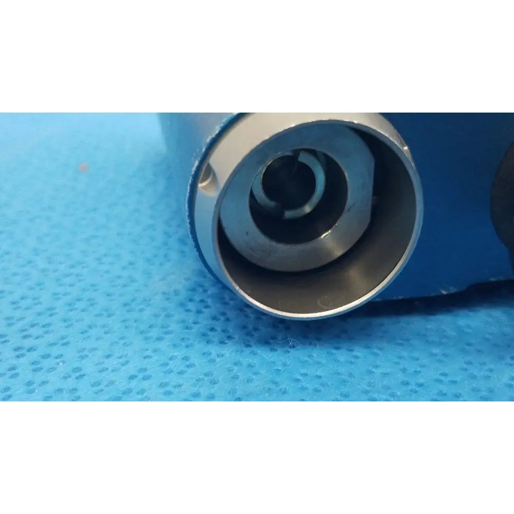 Silver metallic cylindrical connector with threaded interior and concentric rings for Stryker remb universal driver