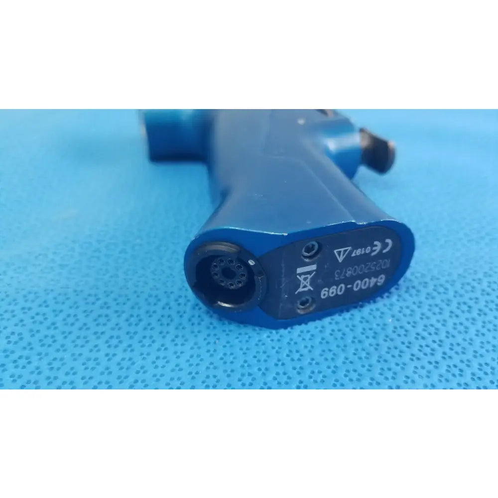 Blue plastic medical equipment air gun with circular nozzle and certification markings on the rear side by smiths medical
