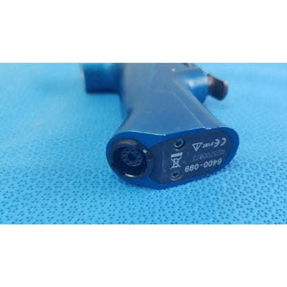 Blue plastic medical equipment air gun with circular nozzle and certification markings on the rear side by smiths medical