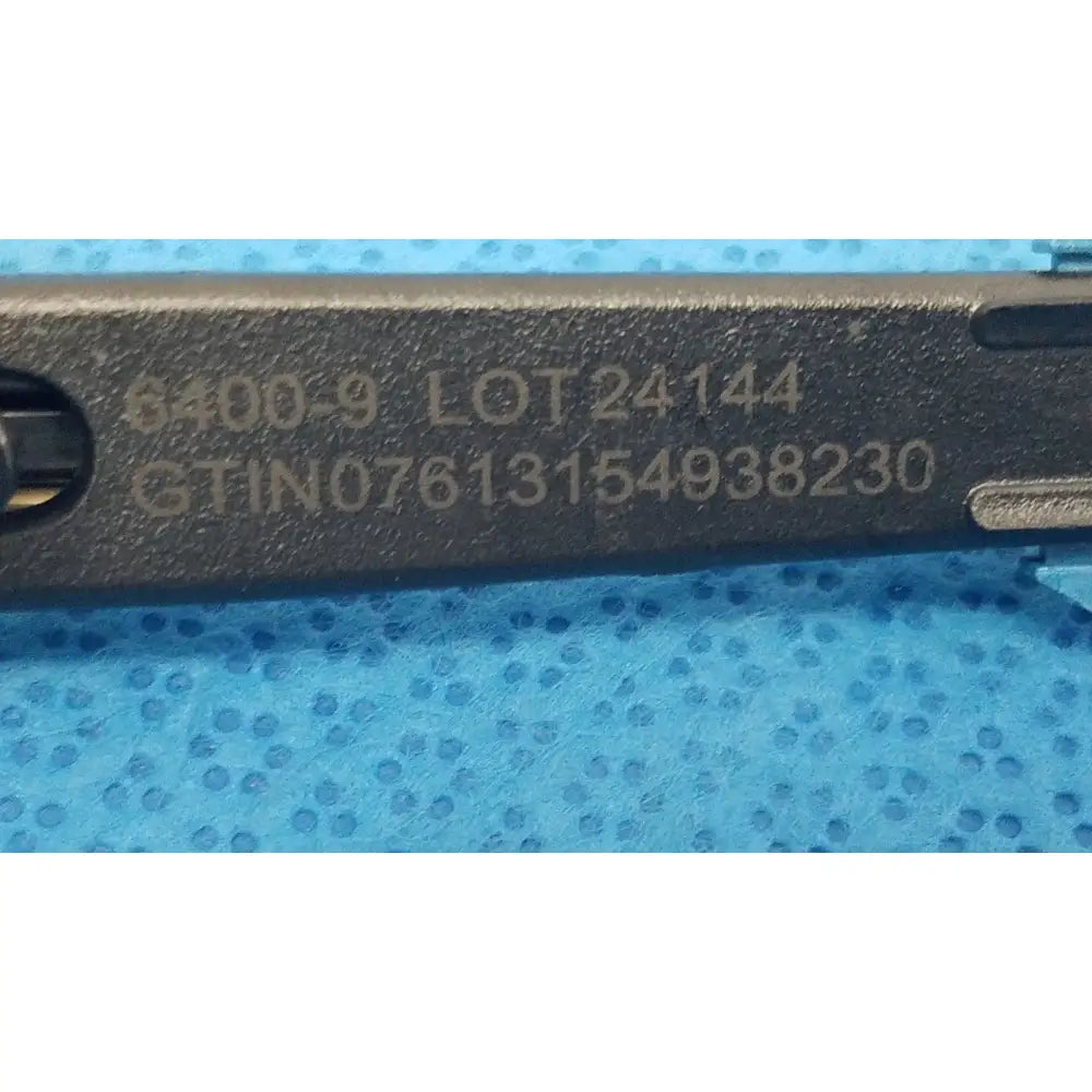 Black metal remb handswitch tool with engraved serial numbers and lot code for reuse medical use on back side