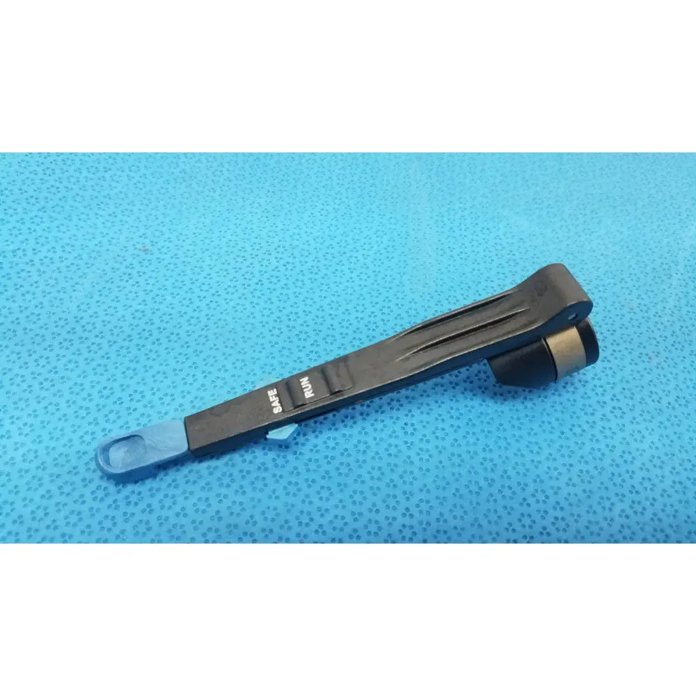 Black plastic remb handswitch with blue tip and engraved safe and run markings for reuse medical use