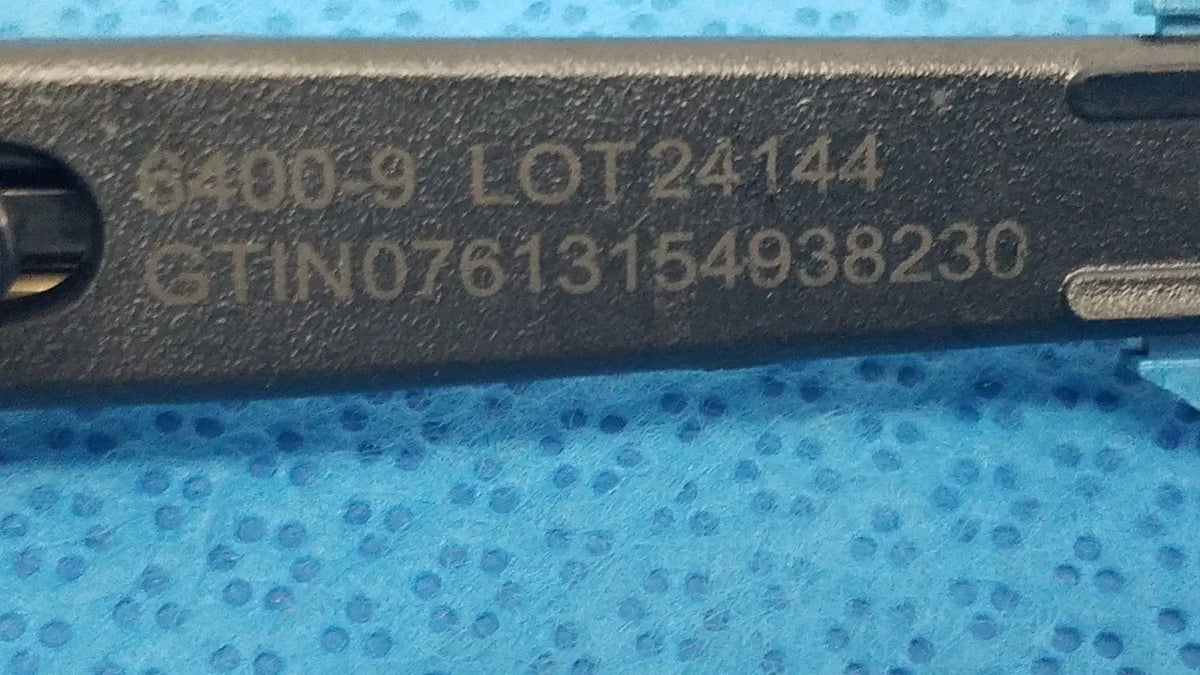 Black metal remb handswitch tool with engraved serial numbers and lot code for reuse medical use on back side