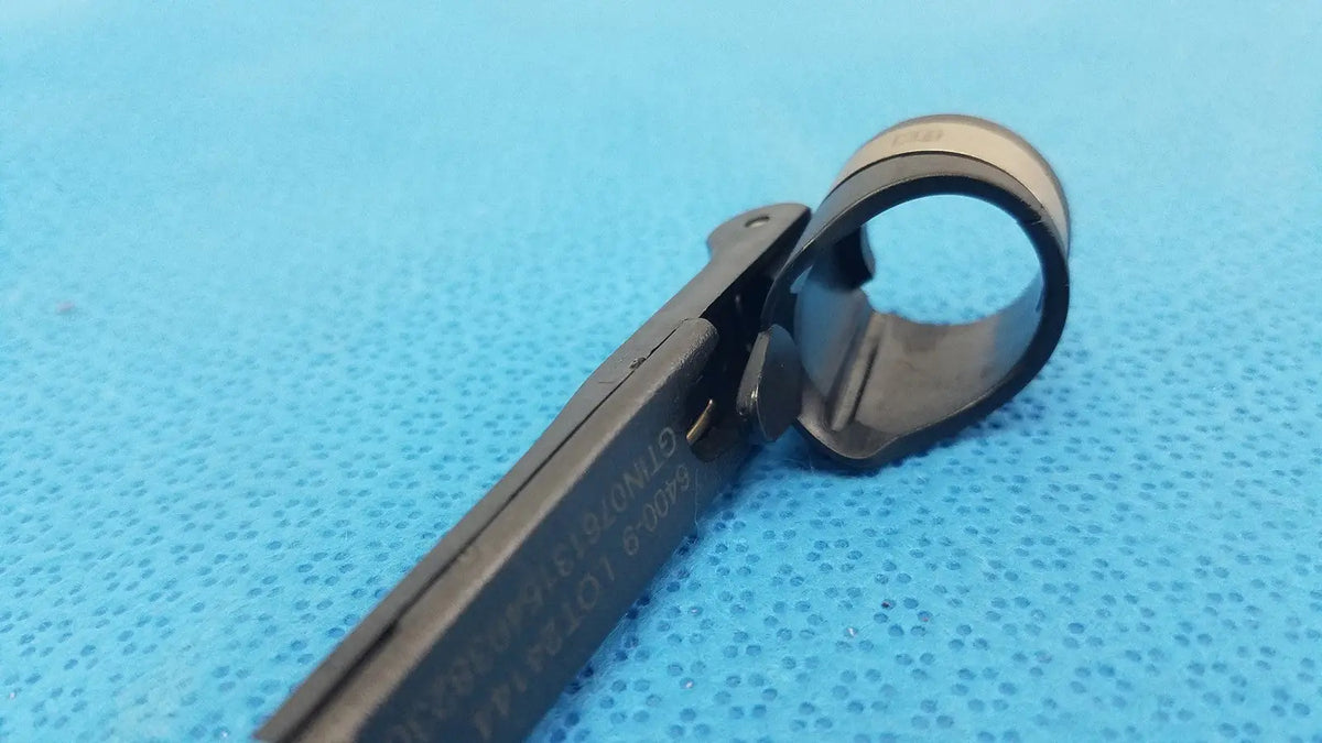 Black metal cable cutter with textured grip and engraved markings on handle for reuse medical remb handswitch applications