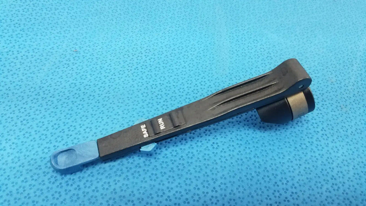 Black plastic remb handswitch with blue tip and engraved safe and run markings for reuse medical use