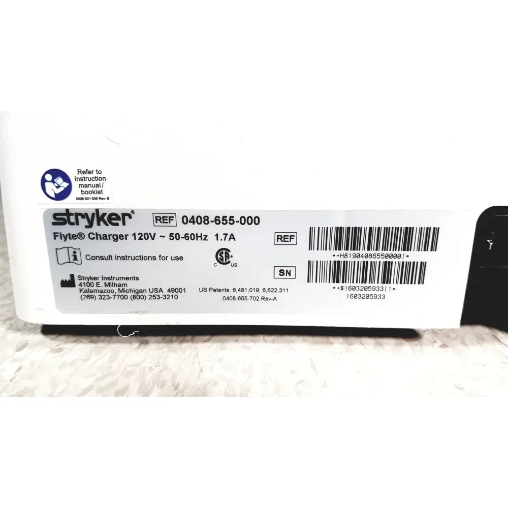 White stryker flyte battery charging station with black accents and barcode label for flyte battery charging
