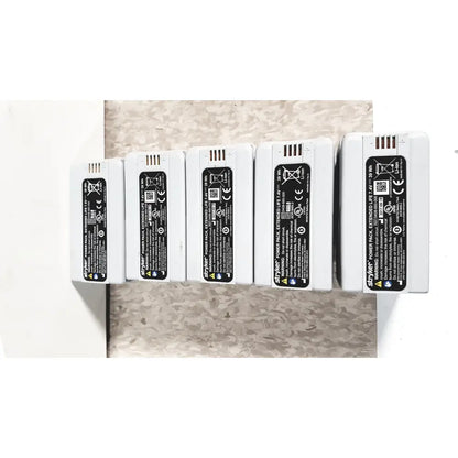 White rectangular styker power pack extended flyte batteries with black labels in stryker 8-slot steri-shield flyte battery charging station