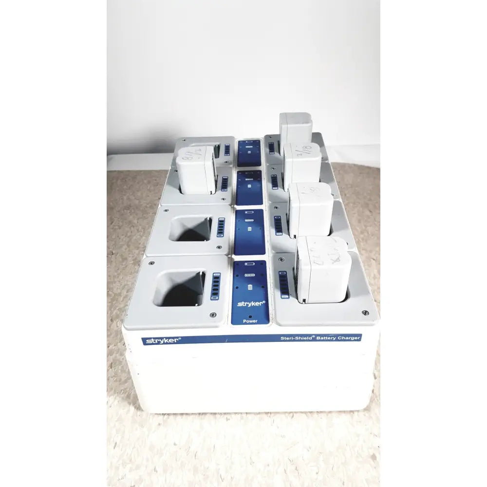 White and blue stryker 8-slot steri-shield flyte battery charging station with multiple slots for flyte battery charging