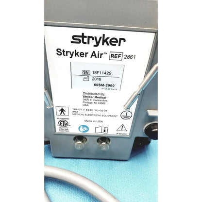 Gray metal stryker air loss pump 2861 with white label showing model and serial number details on the back side