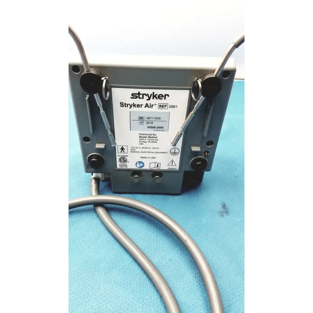 Gray metallic stryker air loss pump 2861 medical electrical unit with silver tubing connected for air loss therapy