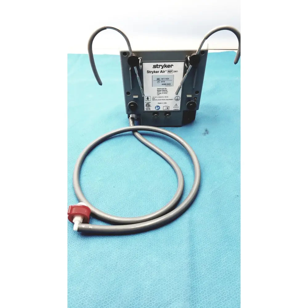 Gray stryker air ref 3061 medical air compressor with coiled tubing and red valve for stryker air loss pump 2861