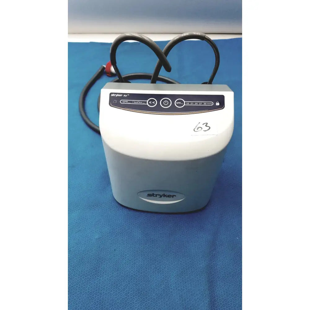 White and gray stryker air loss pump 2861 medical device with black control panel and coiled cables for pressure therapy