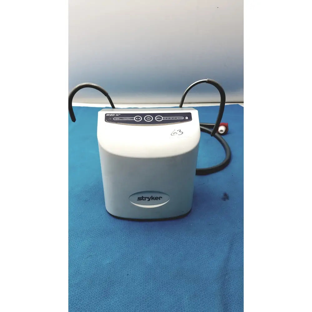 White stryker air loss pump 2861 medical device with black control panel and coiled cables for patient care