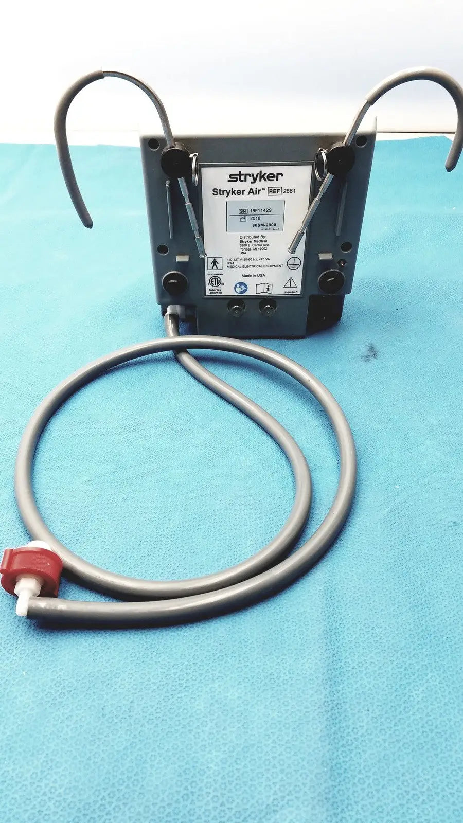 Gray stryker air ref 3061 medical air compressor with coiled tubing and red valve for stryker air loss pump 2861