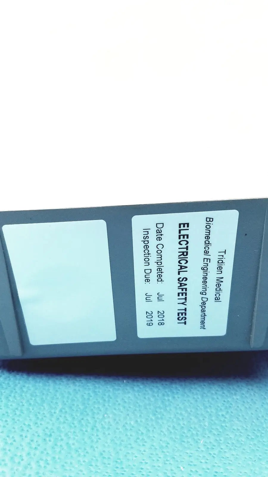 Gray tidien medical electrical safety test device with inspection label on back of stryker air loss pump 2861 unit