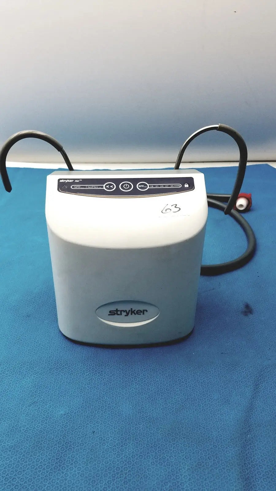 White stryker air loss pump 2861 medical device with black control panel and coiled cables for patient care
